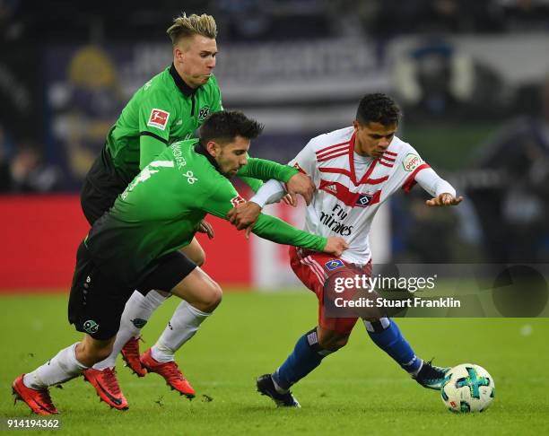 Douglas Santos of Hamburg is challenged by Julian Korb of Hannover during the Bundesliga match between Hamburger SV and Hannover 96 at...