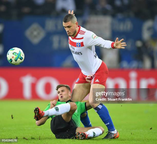 Kyriakos Papadopoulos of Hamburg is challenged by Niclas Fllkrug of Hannover during the Bundesliga match between Hamburger SV and Hannover 96 at...