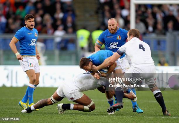 Tommaso Benvenuti of Italy is tackled by Sam Simmonds and Joe Launchbury of England during the NatWest Six Nations match between Italy and England at...