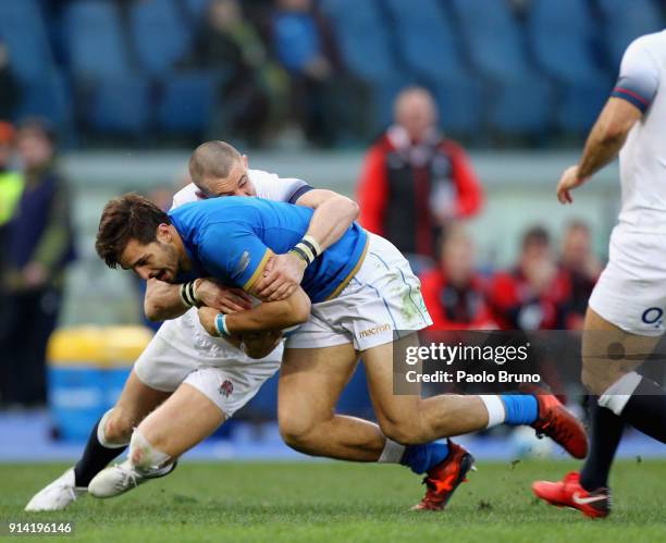 Tommaso Benvenuti of Italy is tackled by Mike Brown of England during the NatWest Six Nations match between Italy and England at Stadio Olimpico on...