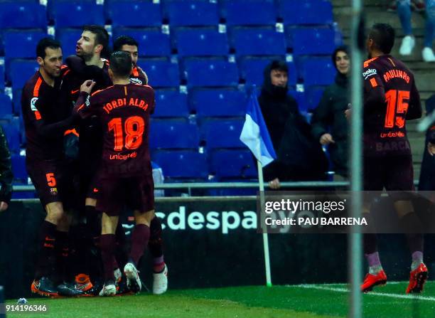 Barcelona's Spanish defender Gerard Pique celebrates a gola with teammates during the Spanish league football match between RCD Espanyol and FC...