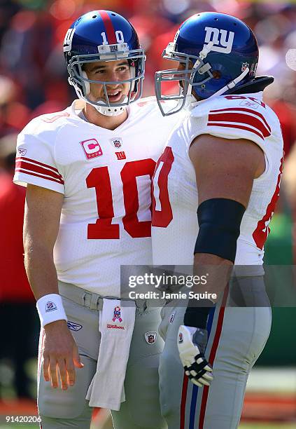 Quarterback Eli Manning and center Shaun O'Hara speak during pregame warm-ups just prior to the start of the game against the Kansas City Chiefs on...