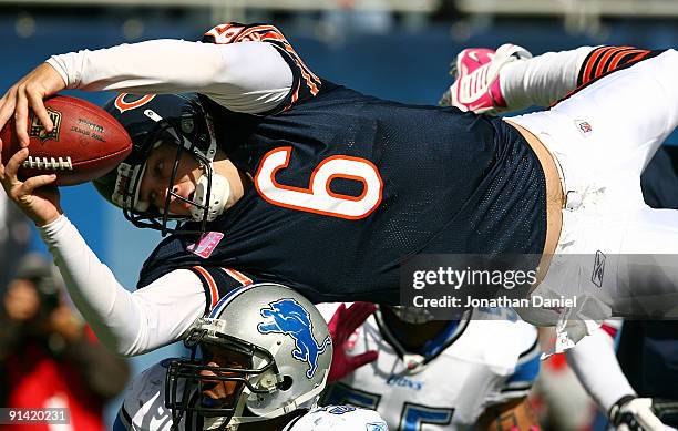 Jay Cutler of the Chicago Bears leaps over Julian Peterson of the Detroit Lions to score a touchdown in the first quarter on October 4, 2009 at...