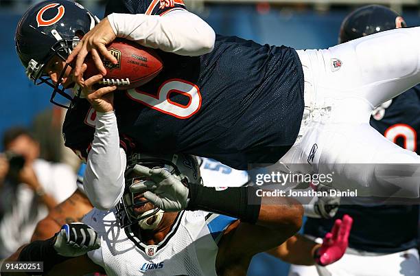 Jay Cutler of the Chicago Bears leaps over Julian Peterson of the Detroit Lions to score a touchdown in the first quarter on October 4, 2009 at...