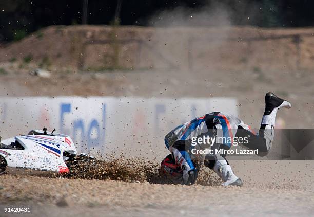 Vladimir Leonov of Russian and Viessmann Kiefer Racing crashes out in front of the top riders during the last lap of the 250 cc race of the Grand...