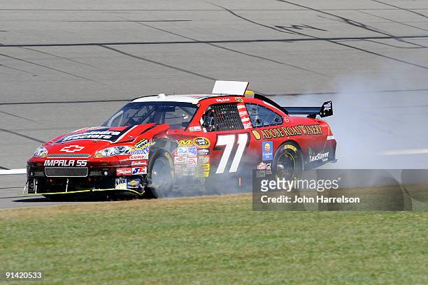 Bobby Labonte, driver of the TRG Motorsports Chevrolet, drives his damaged car towards the garage during the NASCAR Sprint Cup Series Price Chopper...