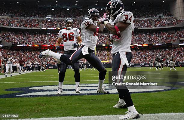Jacoby Jones of the Houston Texans celebrates a kickoff return for a touchdown with James Casey and Dominique Barber during play against the Oakland...