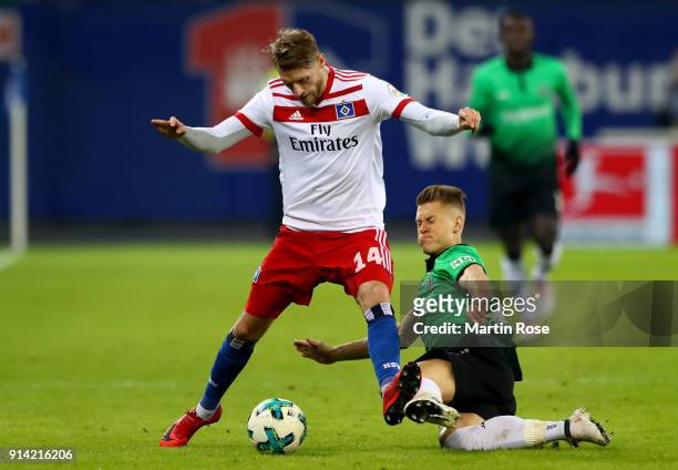 Aaron Hunt of Hamburg and Matthias Ostrzolek of Hannover battle for the ball during the Bundesliga match between Hamburger SV and Hannover 96 at...