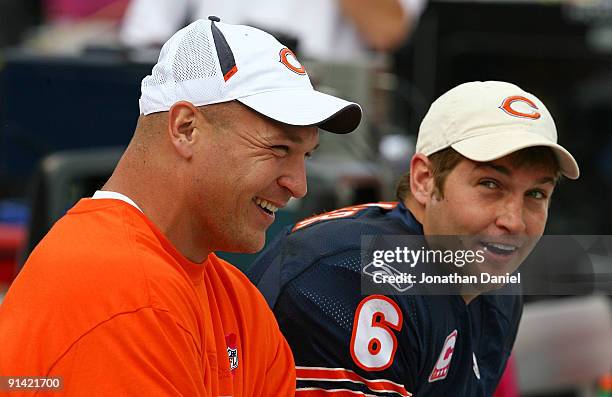 Injured linebacker Brian Urlacher of the Chicago Bears laughs with Jay Cutler on the bench during a game against the Detroit Lions on October 4, 2009...