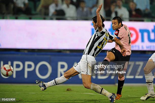 Fabrizio Miccoli of Palermo kicks the ball as Vincenzo Iaquinta of Juventus reacts during the Serie A match played between US Citta di Palermo and...