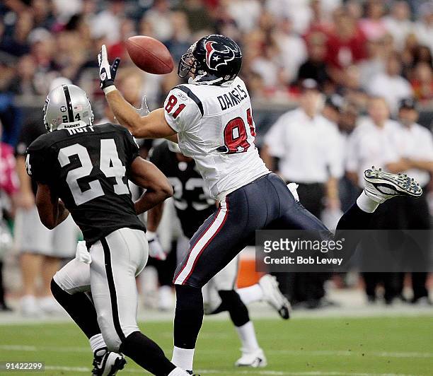Tight-end Owen Daniels of the Houston Texans can't make the catch as he is defended by safety Michael Huff of the Oakland Raiders at Reliant Stadium...