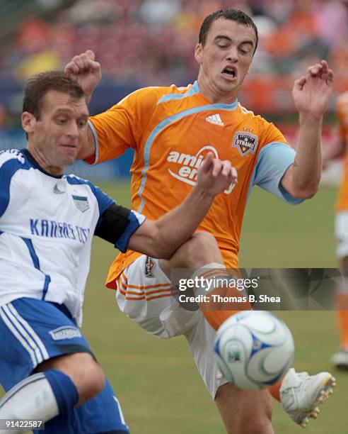 Cam Weaver of the Houston Dynamo kicks the ball against Jimmy Conrad of the Kansas City Wizards on October 4, 2009 at Robertson Stadium in Houston,...