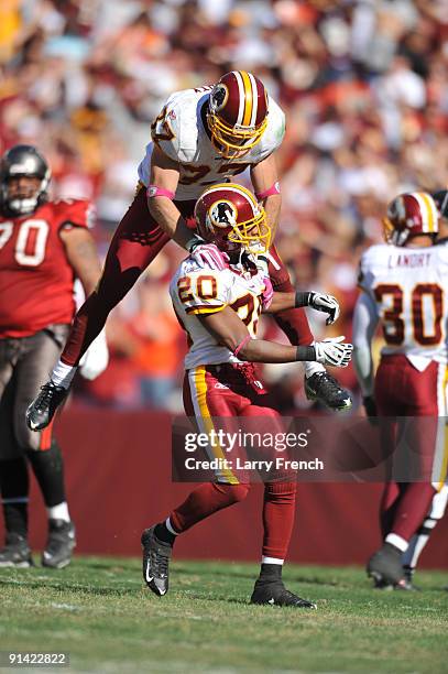 Reed Doughty of the Washington Redskins celebrates a touchdown with Justin Tryon against the Tampa Bay Buccaneers at FedExField on October 4, 2009 in...