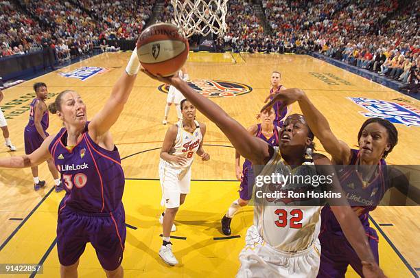 Ebony Hoffman of the Indiana Fever battles Nicole Ohlde and DeWanna Bonner of the Phoenix Mercury during Game Three of the WNBA Finals at Conseco...