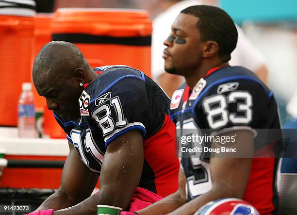 Wide receivers Terrell Owens and Lee Evans of the Buffalo Bills react on the bench late in the fourth quarter against the Miami Dolphins at Land...