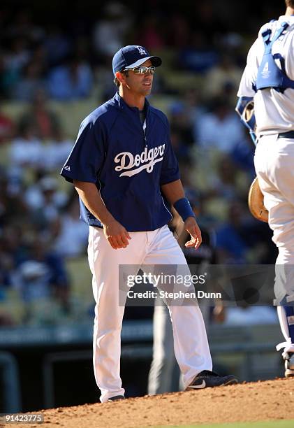 Brad Ausmus of the Los Angeles Dodgers, who acted as manager for the day, goes to the mound to make a pitching change against the Colorado Rockies on...