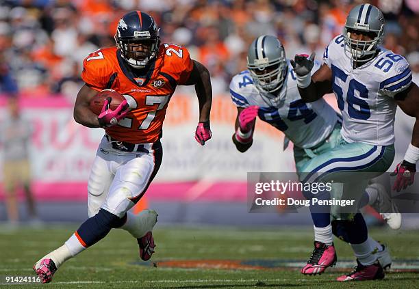 Running back Knowshon Moreno of the Denver Broncos rushes as DeMarcus Ware and Bradie James of the Dallas Cowboys pursue during NFL action at Invesco...