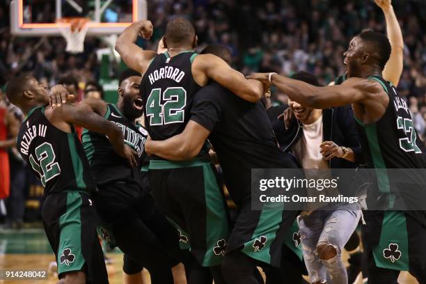 Al Horford is mobbed by the rest of the Boston Celtics after scoring the game winning shot at the end of the game against the Portland Trail Blazers...