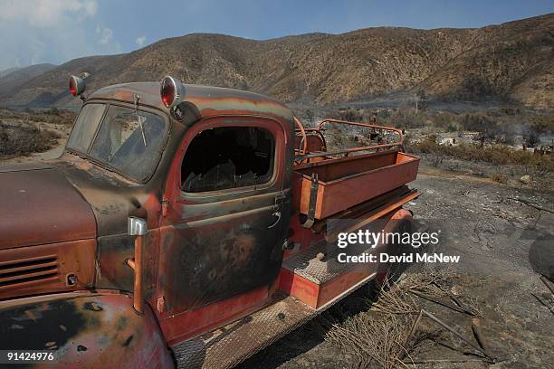 The scorched remains of an old-fashion fire truck are left behind by the 3,500-acre Sheep fire as it advances toward the evacuated mountain town of...