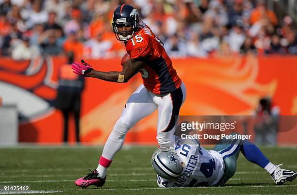 Brandon Marshall of the Denver Broncos makes a reception as Bobby Carpenter of the Dallas Cowboys makes the tackle during NFL action at Invesco Field...