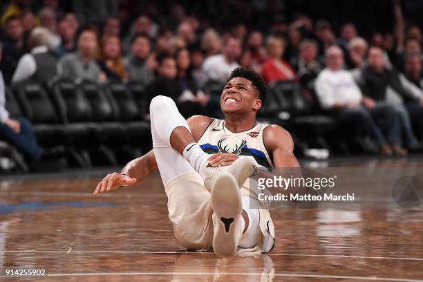 Giannis Antetokounmpo of the Milwaukee Bucks reacts after injuring his right ankle during the game against the Brooklyn Nets at Barclays Center on...