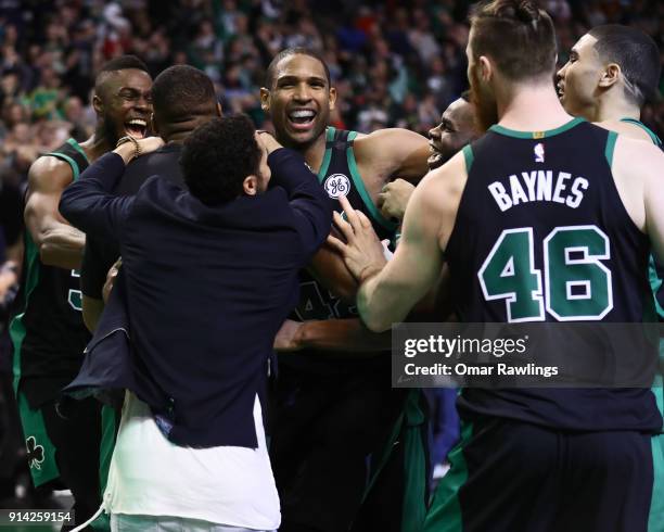 Al Horford of the Boston Celtics is mobbed by the rest of the Boston Celtics team after scoring the game winning shot at the end of the fourth...