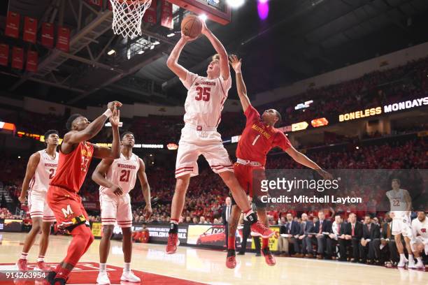 Nate Reuvers of the Wisconsin Badgers drives to the basket over Anthony Cowan Jr. #1 of the Maryland Terrapins during a college basketball game at...