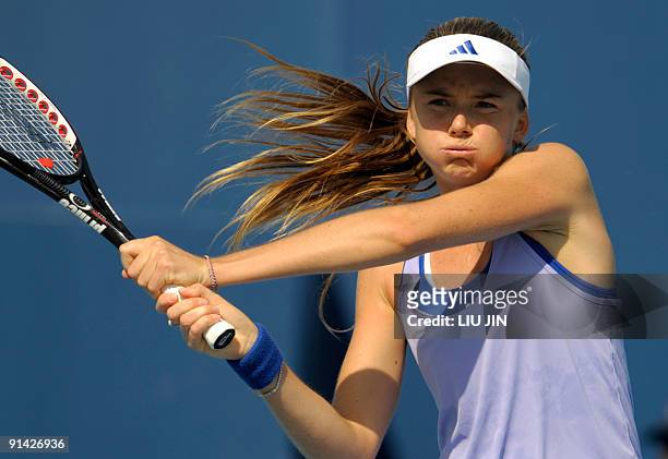 Daniela Hantuchova of Slovakia returns a shot against Carla Suarez Navarro of Spain during their match of the China Open at the National Tennis...