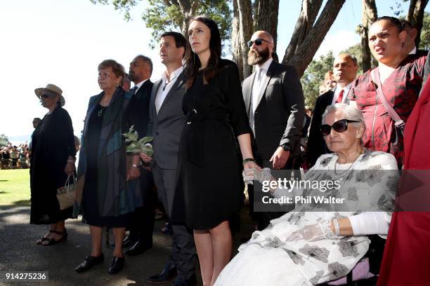 New Zealand Prime Minister Jacinda Ardern holds hands with Titewhai Harawira alongside her partner Clarke Gayford as they recieve a traditional...