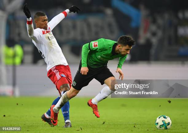 Walace; of Hamburg is challenged by Julian Korb of Hannover during the Bundesliga match between Hamburger SV and Hannover 96 at Volksparkstadion on...