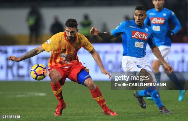 Benevento's Italian midfielder Danilo Cataldi controls the ball next to Napoli's Brazilian midfielder Allan during the Italian Serie A football match...