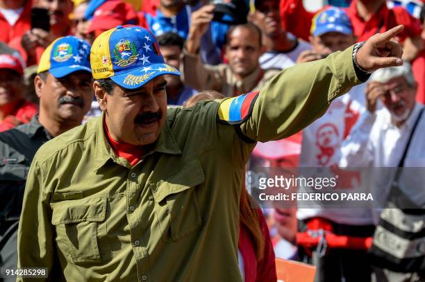 Venezuelan President Nicolas Maduro greets supporters during a rally to commemorate the 26th anniversary of late Venezuelan President Hugo Chavez's...