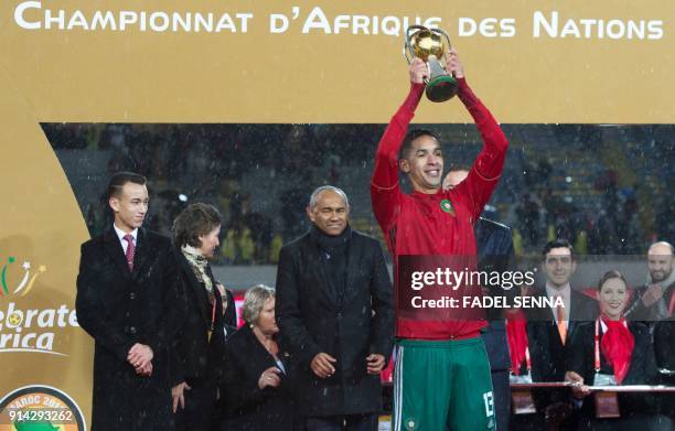 Morocco's Badr Banoun holds the trophy after Morocco won the final football match of the African Nations Championship against Nigeria at the Mohammed...