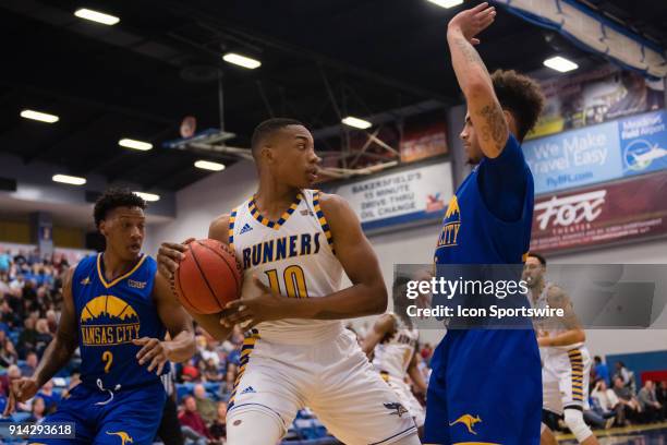 Cal State Bakersfield Roadrunners guard Justin Davis looks to pass the ball with UMKC Kangaroos guard Broderick Robinson defending during the game...