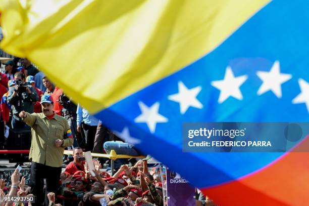 Venezuelan President Nicolas Maduro greets supporters during a rally to commemorate the 26th anniversary of late Venezuelan President Hugo Chavez's...