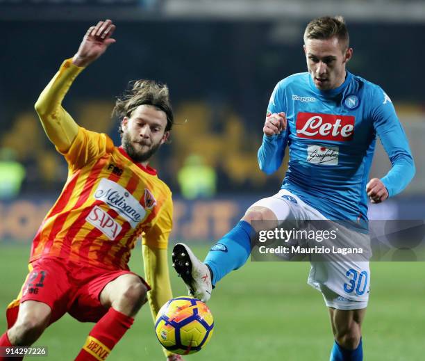 Andrea Costa of Benevento competes for the ball with Marko Rog of Napoli during the serie A match between Benevento Calcio and SSC Napoli at Stadio...