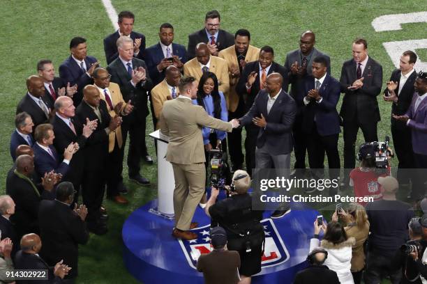 Watt of the Houston Texans is presented with the Walter Payton NFL Man of the Year trophy prior to the game between the New England Patriots and the...