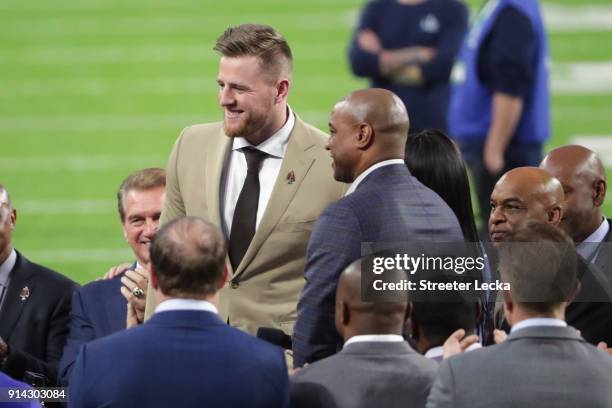 Watt of the Houston Texans is presented with the Walter Payton NFL Man of the Year trophy prior to the game between the New England Patriots and the...