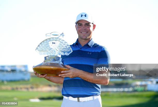 Gary Woodland poses with the trophy after winning the Waste Management Phoenix Open at TPC Scottsdale on February 4, 2018 in Scottsdale, Arizona.