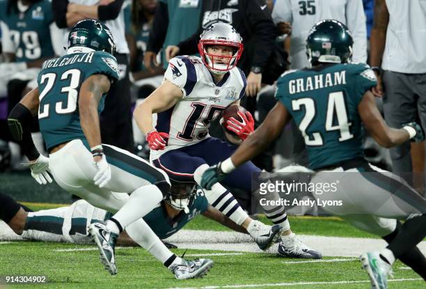 Chris Hogan of the New England Patriots runs with the ball after a reception, chased by Rodney McLeod and Corey Graham of the Philadelphia Eagles,...