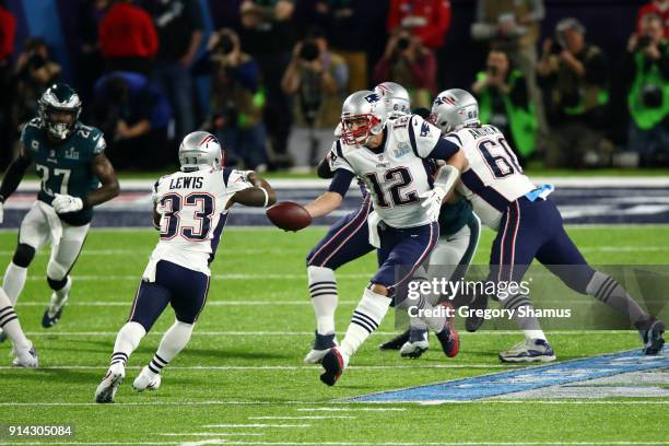 Tom Brady hands the ball offsides to Dion Lewis of the New England Patriots against the Philadelphia Eagles in the first quarter of Super Bowl LII at...