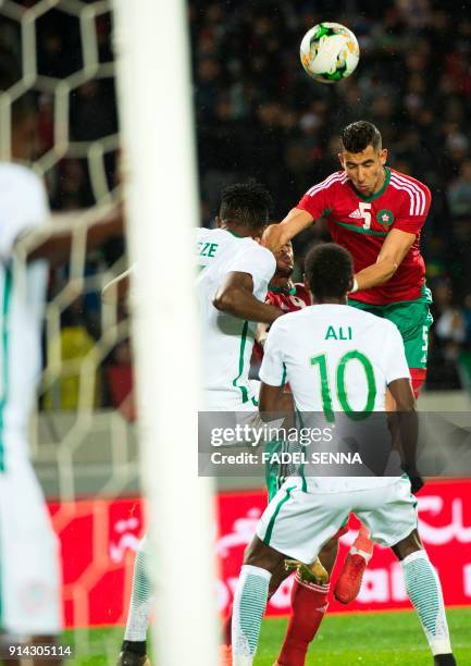 Morocco's Jawad El Yamiq heads the ball against Nigeria's Rabiu Ali during the African Nations Championship football final between Morocco and...