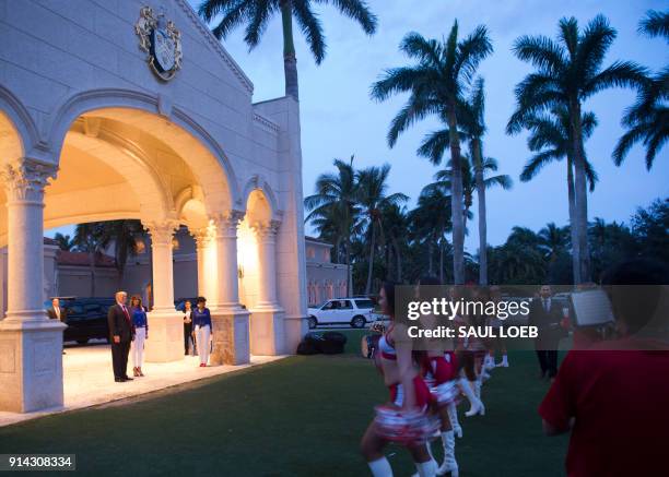 President Donald Trump and First Lady Melania Trump watch the Florida Atlantic University Marching Band and cheerleaders perform prior to a Super...