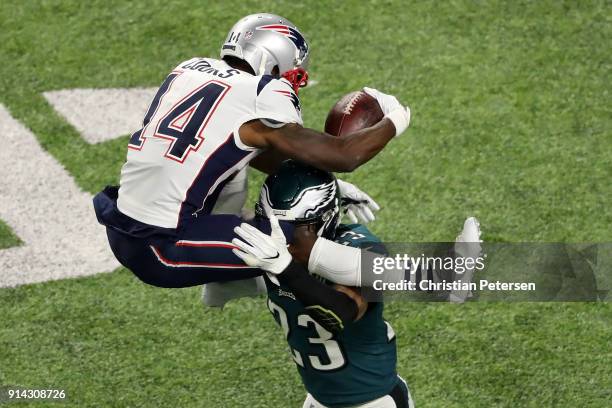 Brandin Cooks of the New England Patriots is stopped by Rodney McLeod of the Philadelphia Eagles as he attempts to leap over the tackle try during...