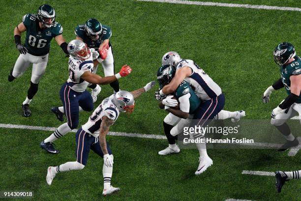 Lawrence Guy of the New England Patriots tackles LeGarrette Blount of the Philadelphia Eagles during the first quarter in Super Bowl LII at U.S. Bank...
