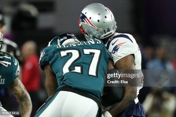 Brandin Cooks of the New England Patriots is tackled by Malcolm Jenkins of the Philadelphia Eagles of the Philadelphia Eagles while attempting a...