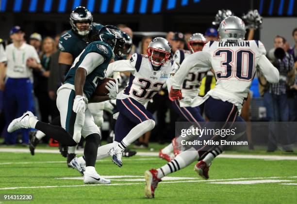 LeGarrette Blount of the Philadelphia Eagles carries the ball against Devin McCourty and Duron Harmon of the New England Patriots during the second...