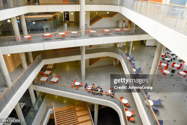 wide view of modern college interior with open plan seating areas on different levels - modern school stock pictures, royalty-free photos & images