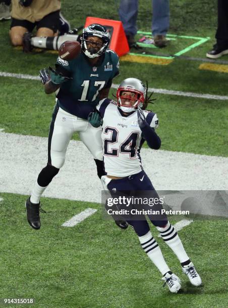 Alshon Jeffery of the Philadelphia Eagles bobbles the pass under pressure from Stephon Gilmore of the New England Patriots as teamamte Duron Harmon...