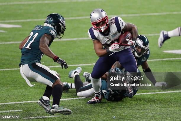James White of the New England Patriots runs the ball past Jalen Mills of the Philadelphia Eagles for a 26-yard touchdown during the second quarter...